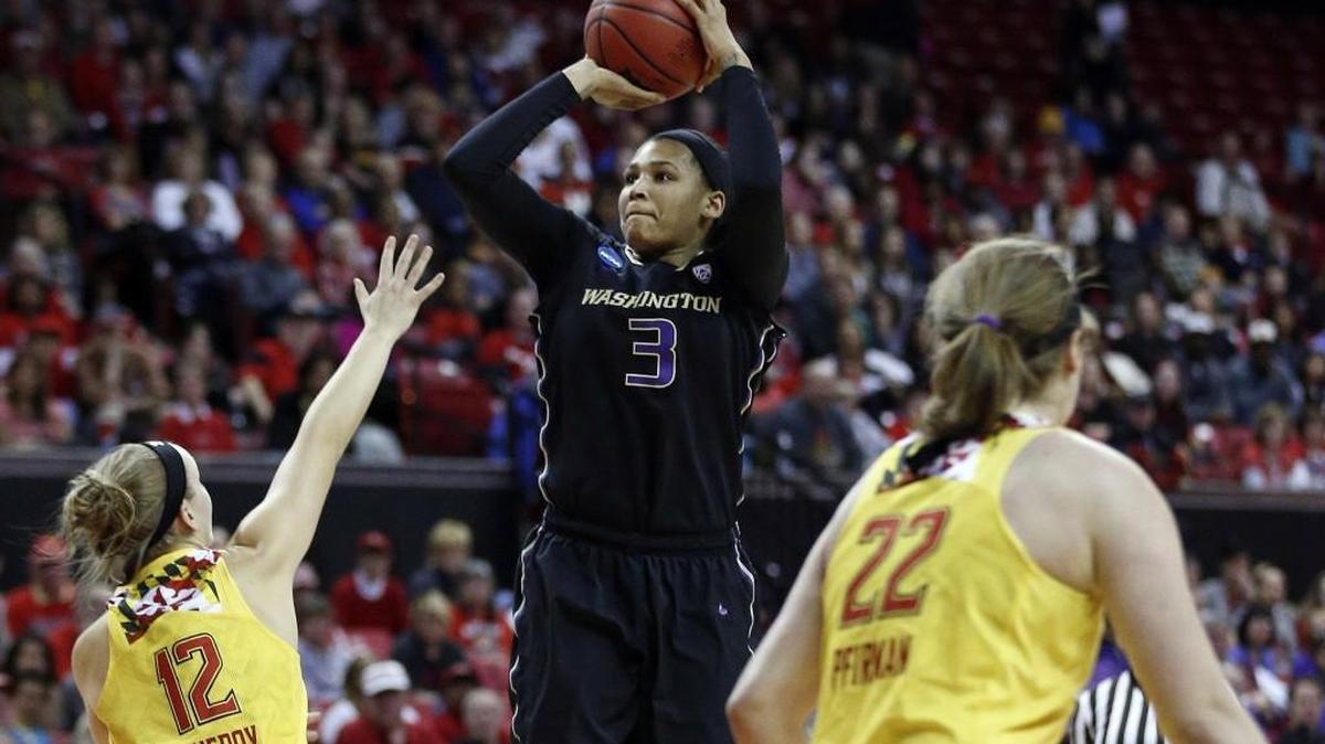 Washington forward Talia Walton, center, shoots over Maryland guard Kristen Confroy, left, and forward Tierney Pfirman in the first half of an NCAA college basketball game in the second round of the NCAA tournament, Monday, March 21, 2016, in College Park, Md.