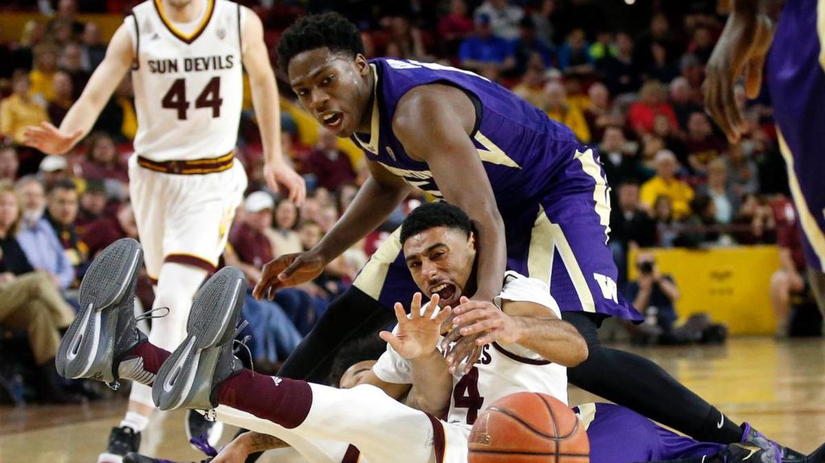UW’s Noah Dickerson, top, attempts a steal from Arizona State’s Andre Spight on Saturday. Dickerson drew three fouls in the first half but survived to play 30 minutes, and he chipped in 10 points.