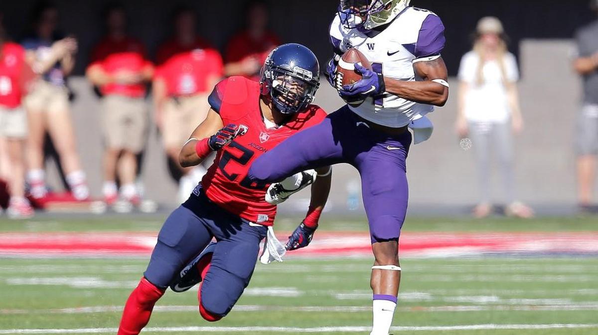 
Washington wide receiver Jaydon Mickens, white jersey, switched his uniform number from No. 4 to No. 1 for his senior season in honor of close friend and teammate John Ross III, who will miss the season after knee surgery.
