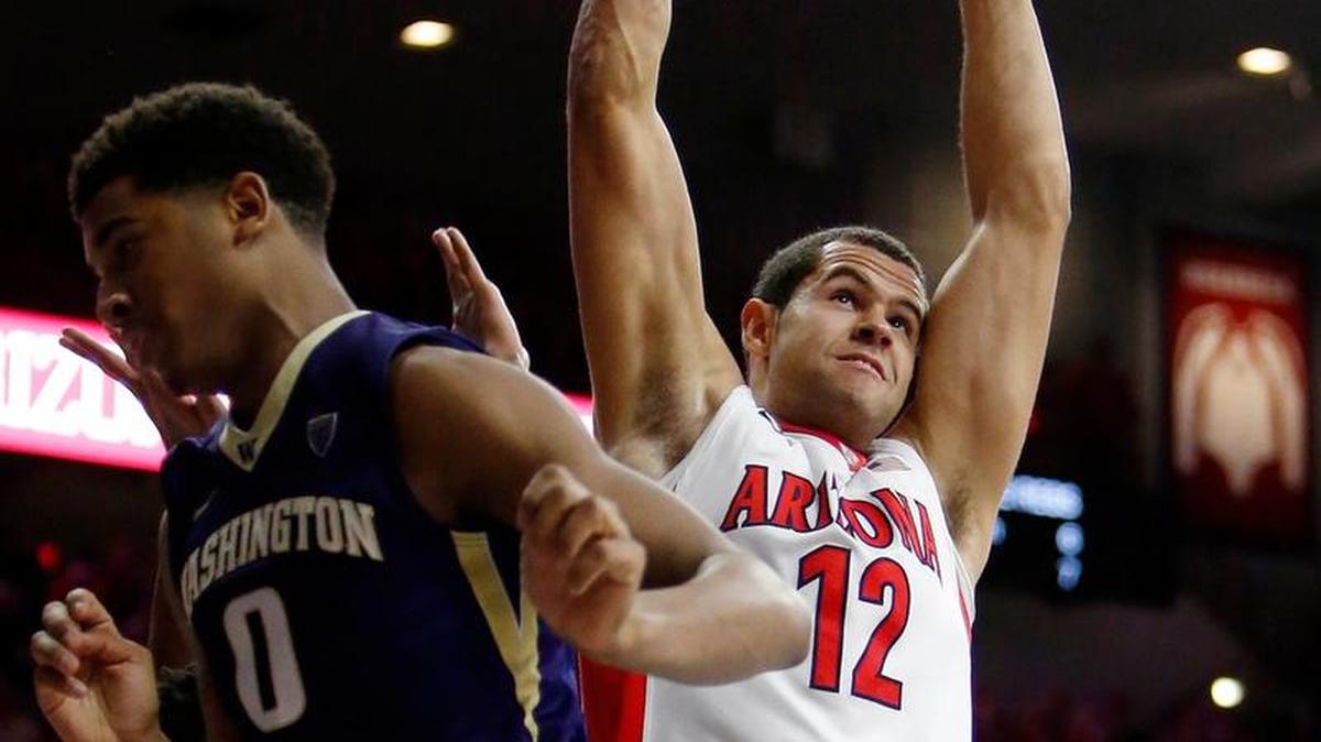 Arizona forward Ryan Anderson (12) dunks next to Washington guard Dejounte Murray (5) and forward Marquese Chriss (0) during the second half of an NCAA college basketball game Thursday, Jan. 14, 2016, in Tucson, Ariz. Arizona defeated Washington 99-67.