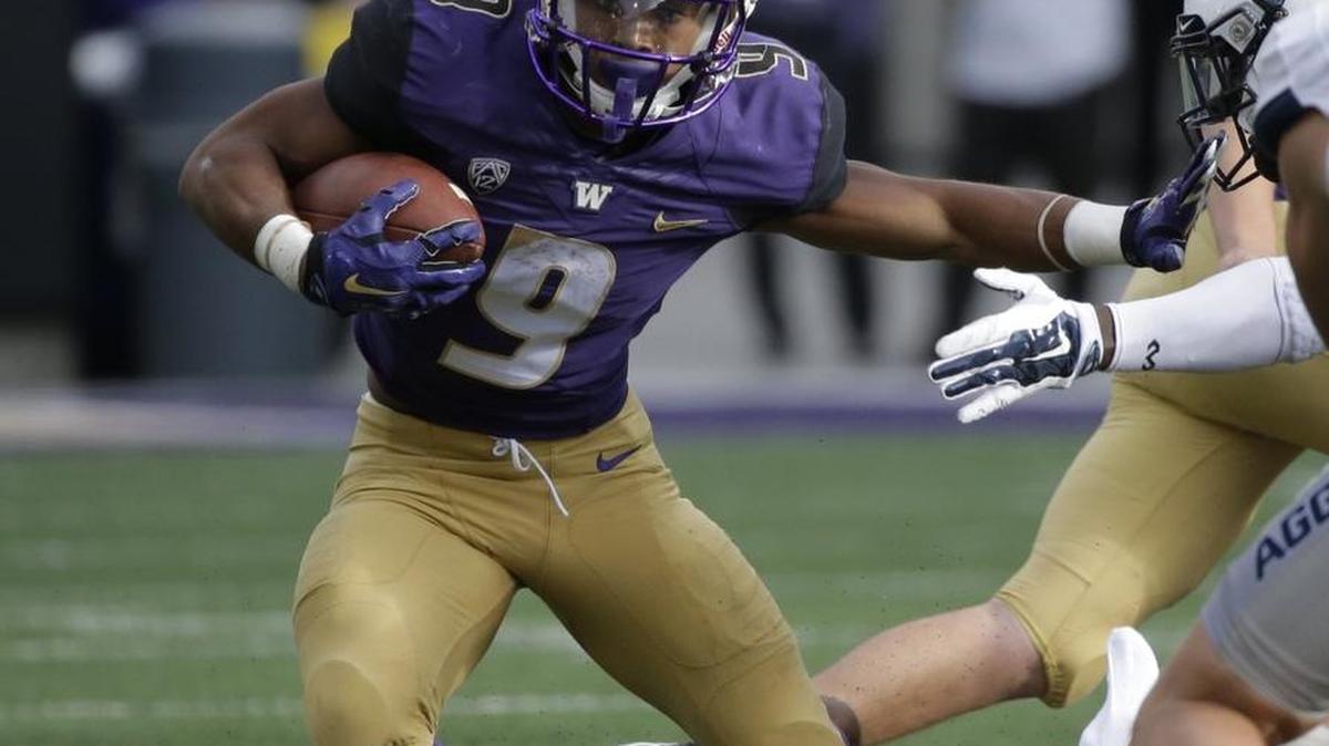 
Washington tailback Myles Gaskin carries the ball in the second half against Utah State on Sept. 19. 
