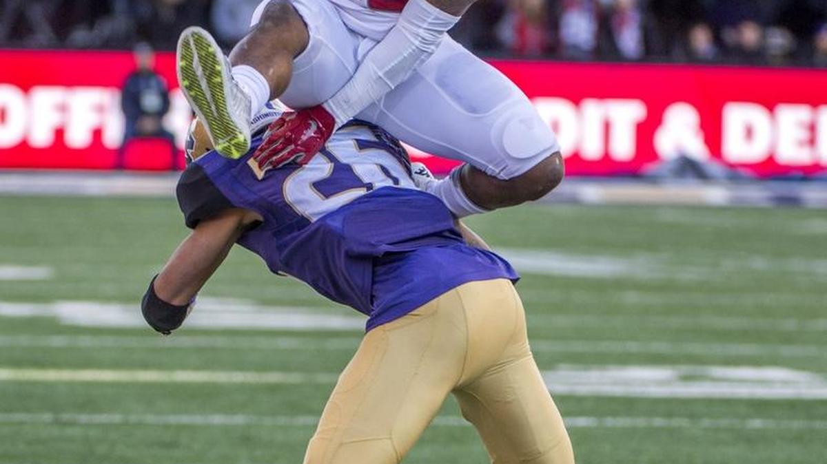 WSU’s Jamal Morrow leaps over UW’s Sidney Jones this past Friday in the first half of the Apple Cup.