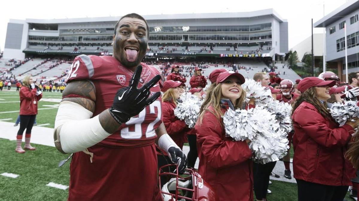 Washington State nose tackle Robert Barber (92) gestures after the Cougars beat Idaho in Pullman in September.