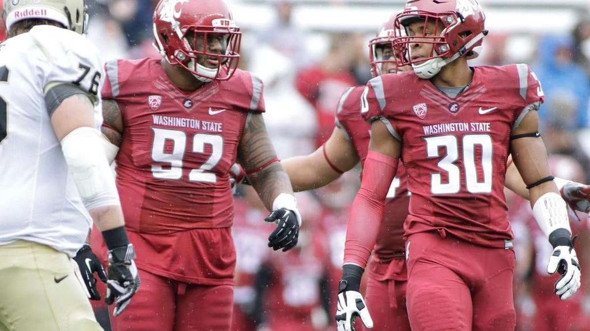 Defensive end Nnamdi Oguayo (30) was on the field Saturday during Washington State’s scrimmage as a full participant for the first time in a few weeks. His impact was felt by the offense.