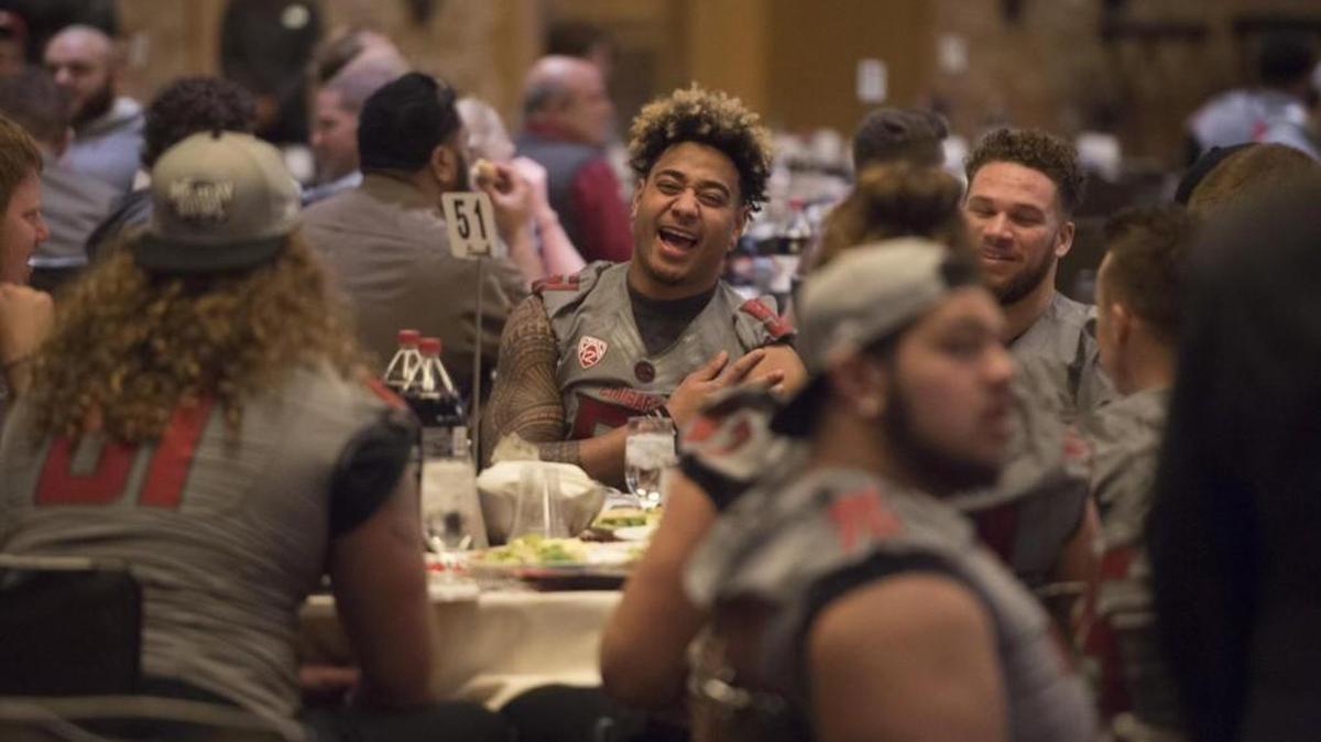 Washington State linebacker Frankie Luvu (51) laughs with teammates during a luncheon before the 2016 Holiday Bowl on Monday at the Hilton Bayfront in San Diego, Calif.