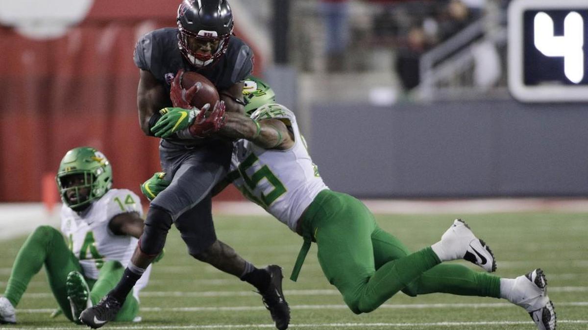 Oregon linebacker A.J. Hotchkins (55) brings down Washington State wide receiver Tavares Martin Jr. (8) during the second half of an NCAA college football game in Pullman, Wash., Saturday, Oct. 1, 2016. Washington State won 51-33.