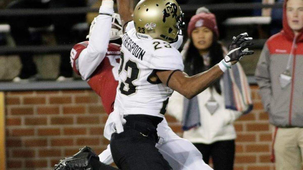Washington State wide receiver Dom Williams, left, hauls in a pass while under pressure from Colorado defensive back Ahkello Witherspoon on Saturday in Pullman. The Cougars won the game, 27-3.
