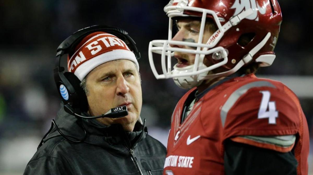 
Washington State’s Mike Leach, left, talks with quarterback Luke Falk, right, on the sideline. Leach is heading into his third season as coach of the Cougars. in the second half of an NCAA college football game against Washington, Saturday, Nov. 29, 2014, in Pullman, Wash. (AP Photo/Ted S. Warren)
