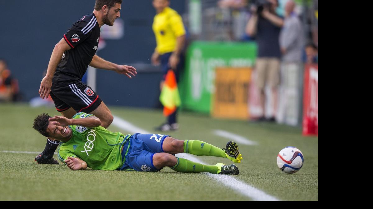 
The Seattle Sounders' Lamar Neagle goes down hard after tangling with DC United's Chris Korb on July 3, 2015, at CenturyLink Field in Seattle. The Sounders have scored just two goals in their past five MLS matches. 

