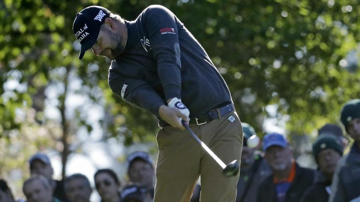 Ryan Moore hits his drive at the fourth hole Friday. After three birdies in the second round, he was at 1-under 143.