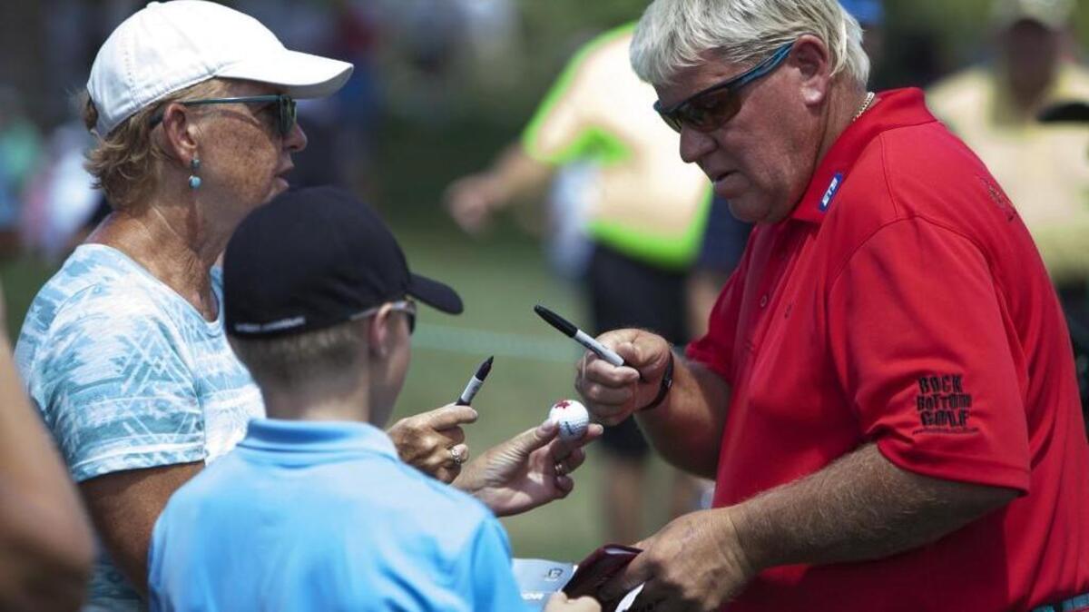 John Daly signs autographs after completing the ninth hole during first round of the U.S. Senior Open on Aug. 11 at Scioto Country Club in Columbus, Ohio. Daly, a Champions Tour rookie, will make his first appearance at the Boeing Classic at TPC Snoqualmie today.