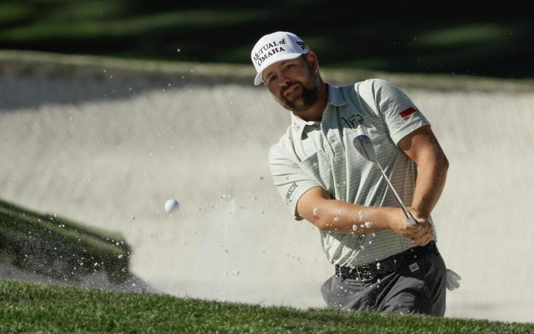 Puallup’s Ryan Moore hits from a bunker on the 10th hole during the third round of the Masters on Saturday. Moore shot a 69 and is tied for fourth, two strokes off the lead.