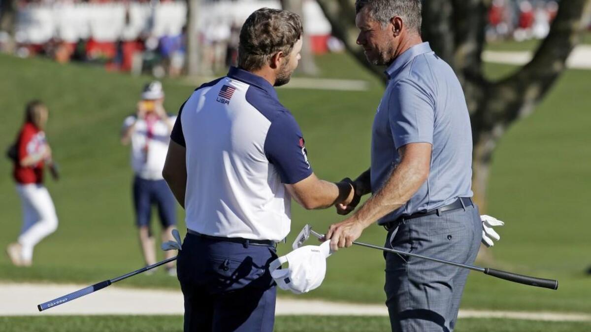 Europeâ€™s Lee Westwoodshakes hands with United Statesâ€™ Ryan Moore after the match gave the USA team enough points to win the Ryder Cup golf tournament Sunday, Oct. 2, 2016, at Hazeltine National Golf Club in Chaska, Minn.