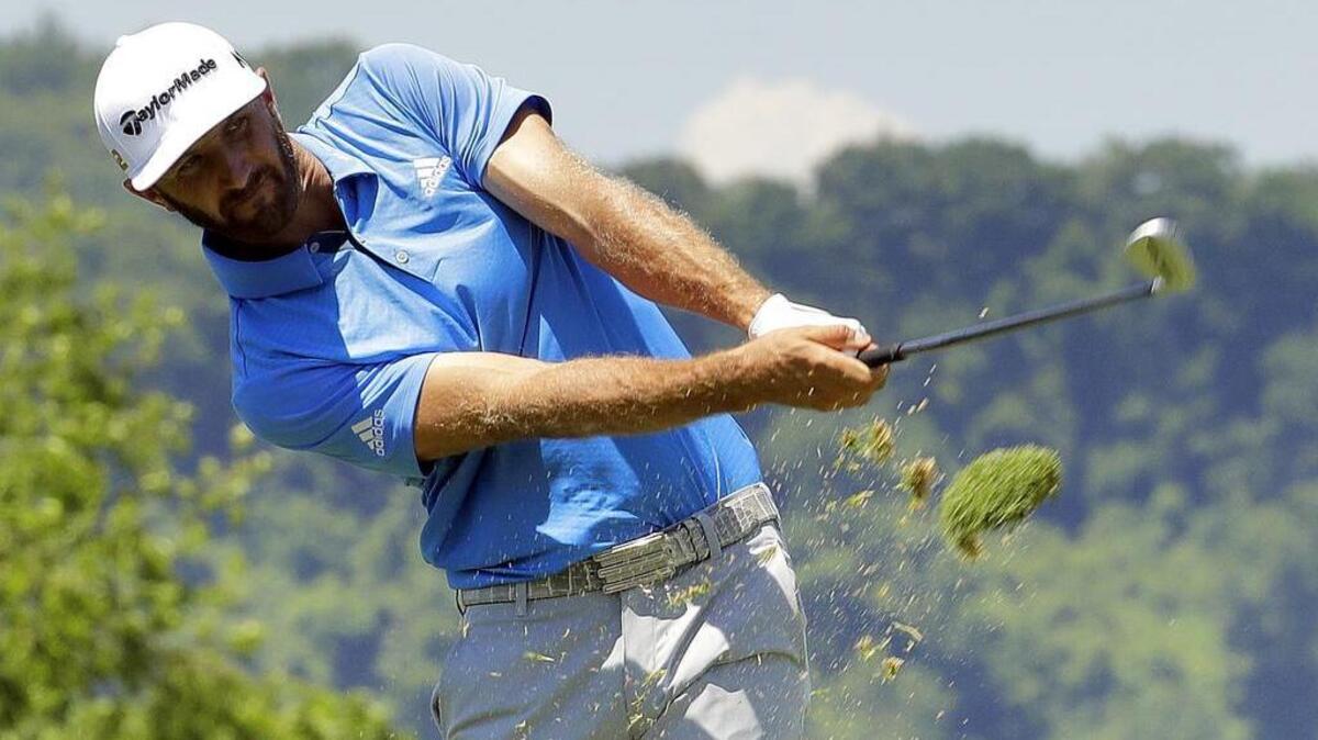 Dustin Johnson hits from the fairway on the 17th hole during the rain-delayed first round of the U.S. Open at Oakmont Country Club on Friday.
