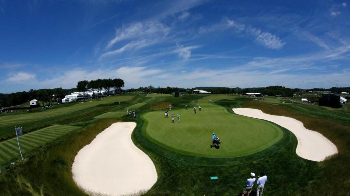 A group of golfers, including 2007 U.S. Open champion Angel Cabrera, practices putting on the 14th green at Oakmont Country Club on Monday in Oakmont, Pennsylvania.