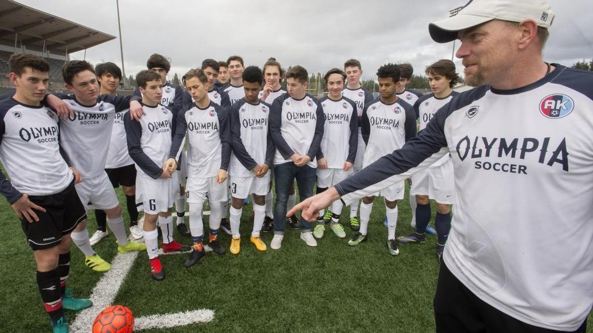 Olympia High soccer coach Ty Johnson talks with his players at soccer practice at Olympia High School in Olympia on Wednesday, Mar. 22, 2017. Johnson wearing a patch, upper left chest, in honor of assistant coach Austin Kelley died tragically in an accident in September.