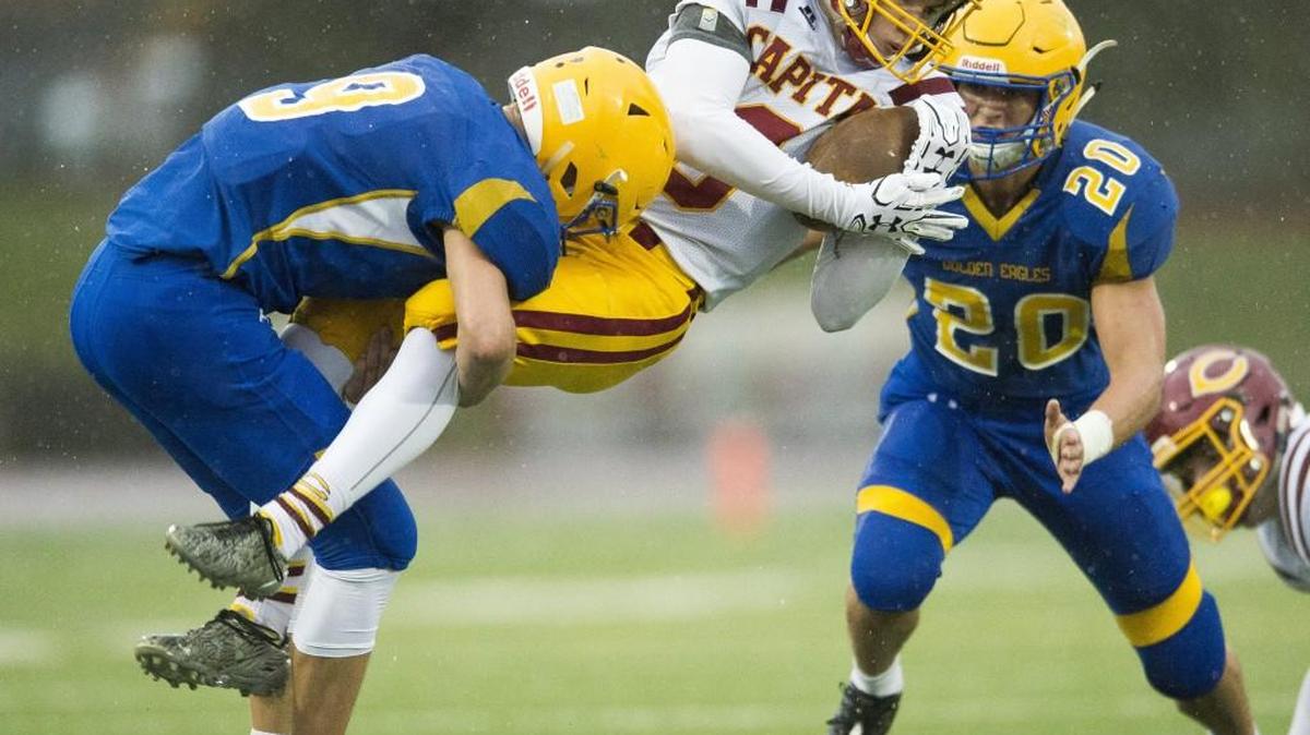 Ferndale's Justice Powell, left, tackles Capital's Chris Penner on Saturday, Nov. 5, at Civic Stadium in Bellingham.