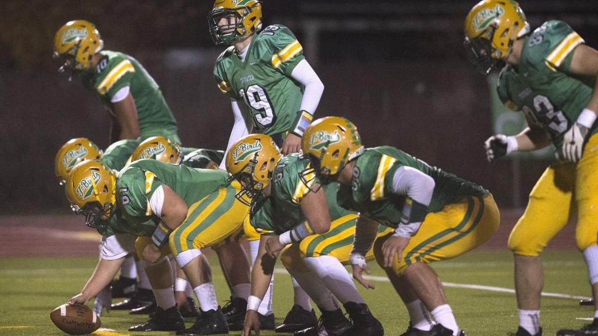 Tumwater quarterback Elias Polito (19) lines up the T-Birds offense against W.F. West during Friday night's football game at Tumwater District Stadium on Oct. 27, 2017.