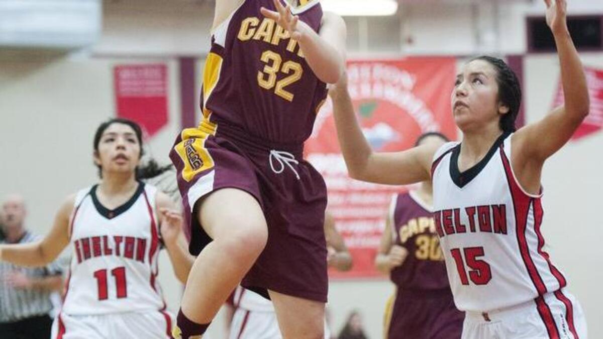 Capital’s Palen Fenton (32) goes up for a shot over Aurora Gouley of Shelton on Friday night.