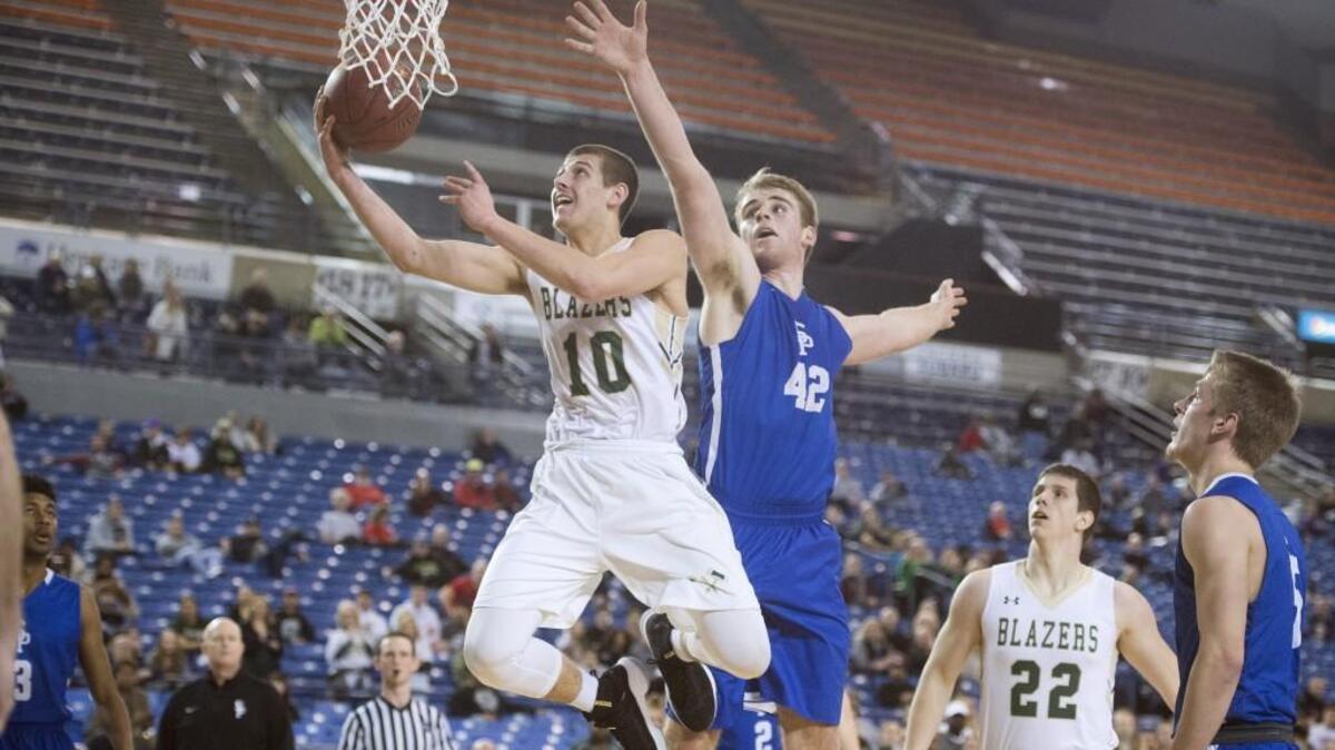 Timberline’s Erik Stevenson flies to the basket ahead of Seattle Prep defender Nic Lynch during Wednesday's opening-round game of the 3A boys basketball state tournament in the Tacoma Dome on Feb. 28, 2018.