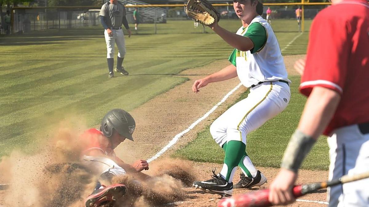 Black Hills baserunner Ethan Loveless scores on a passed ball as Tumwater pitcher Joseph Brascher looks for the throw from his catcher in the first inning. The win places the Wolves as the No. 3 seed out of the 2A Evergreen Conference for the District 4 tournament.