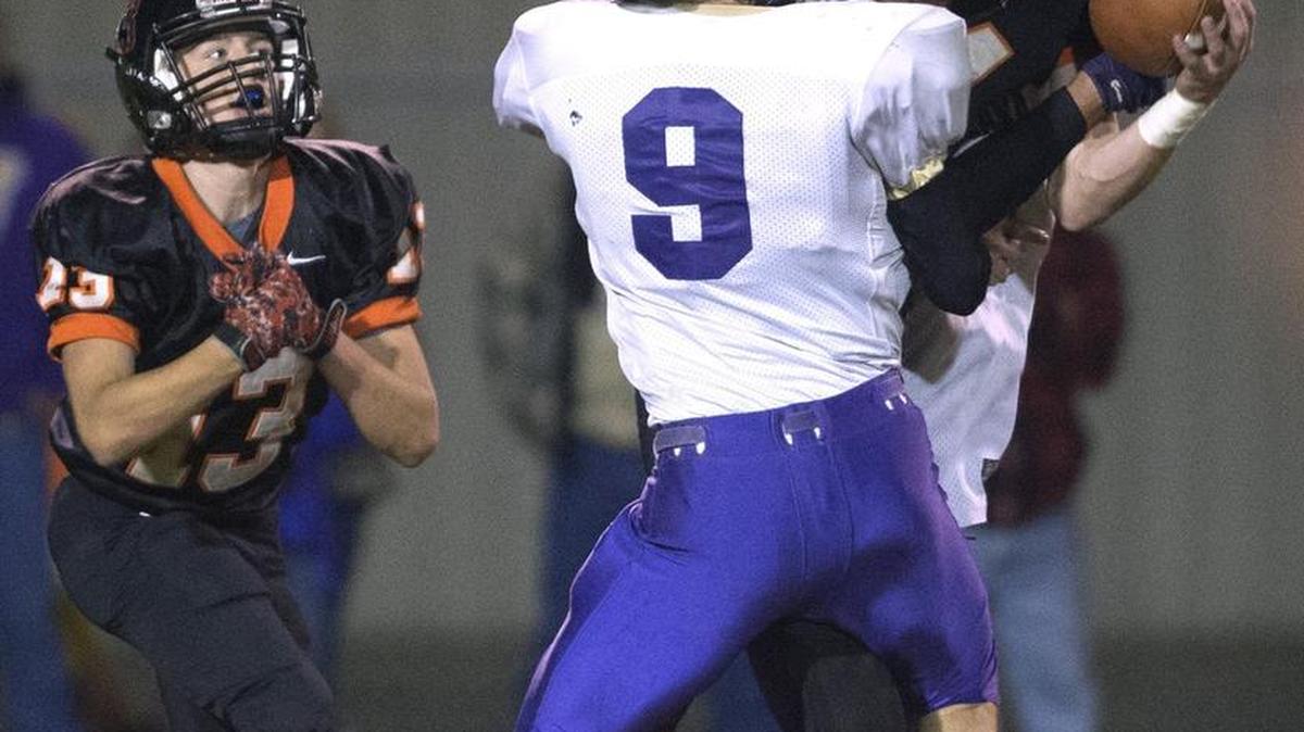 Rainier tailback Dillon Stancil (24) wrestles in a pass reception against Onalaska defensive back Tyler Wallace. Stancil also caught the winning TD pass as time expired.