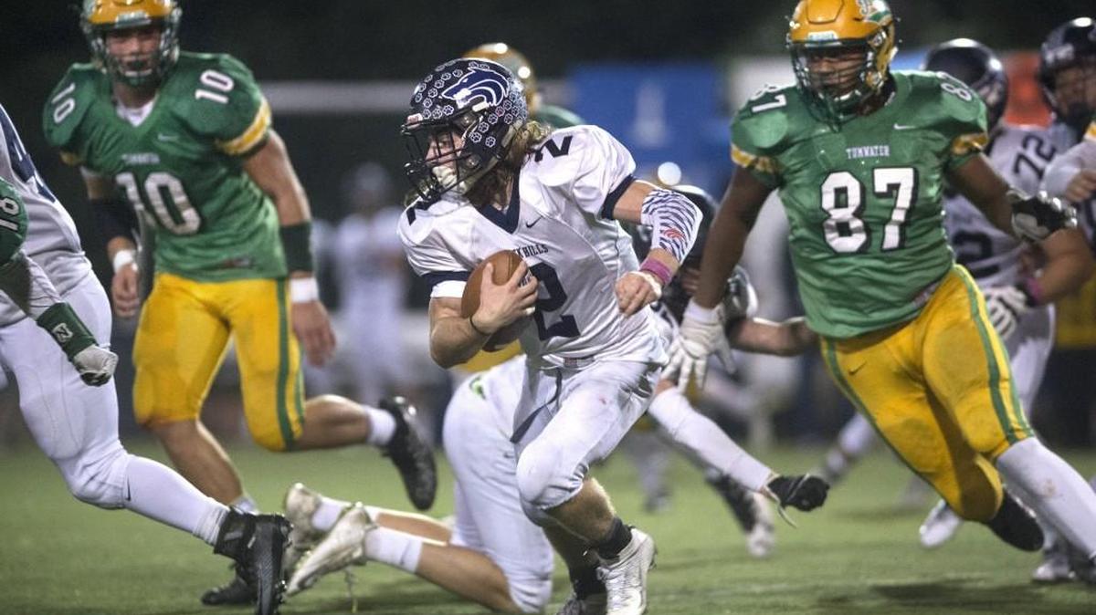 Black Hills running back Kyler Nygren looks for running room between Tumwater defenders Cade Otton (10) and Lazarus Williams during the Pioneer Bowl at Tumwater District Stadium on Oct. 21.