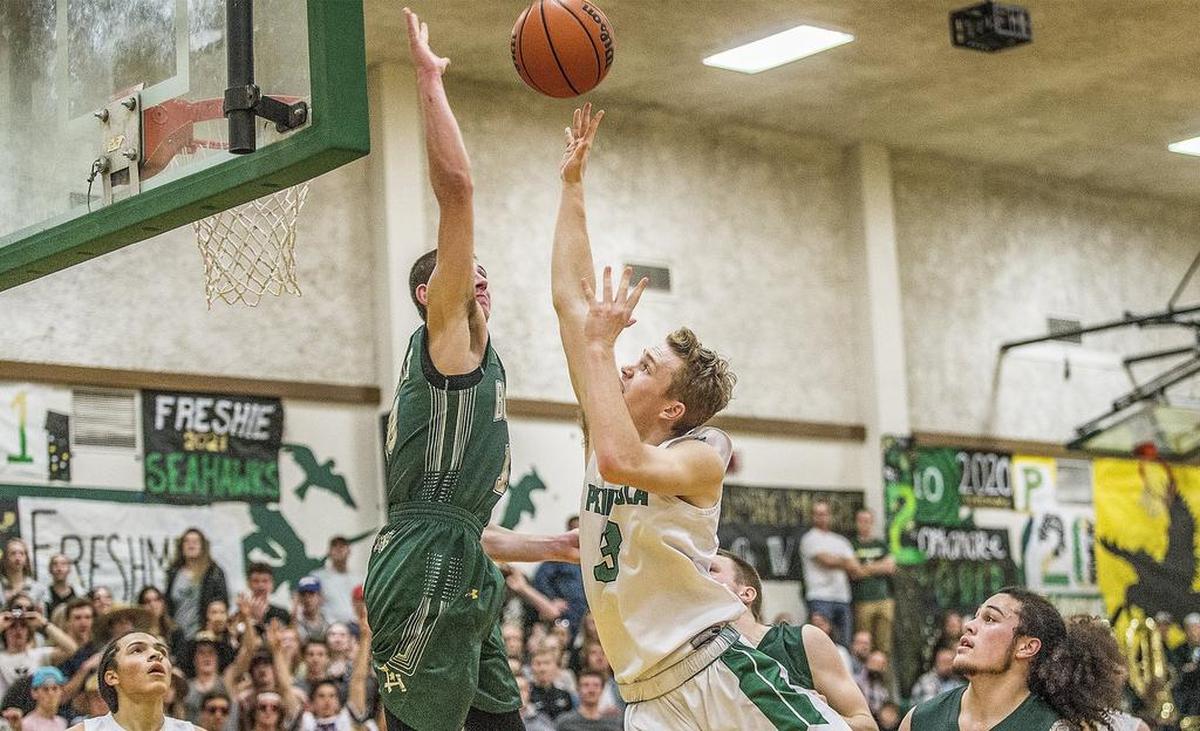 Timberline guard Erik Stevenson (10) blocks a shot by Peninsula guard Sam Miller (3) during a 3A South Sound Conference basketball matchup at Peninsula High School Friday, Jan. 12, 2018.
