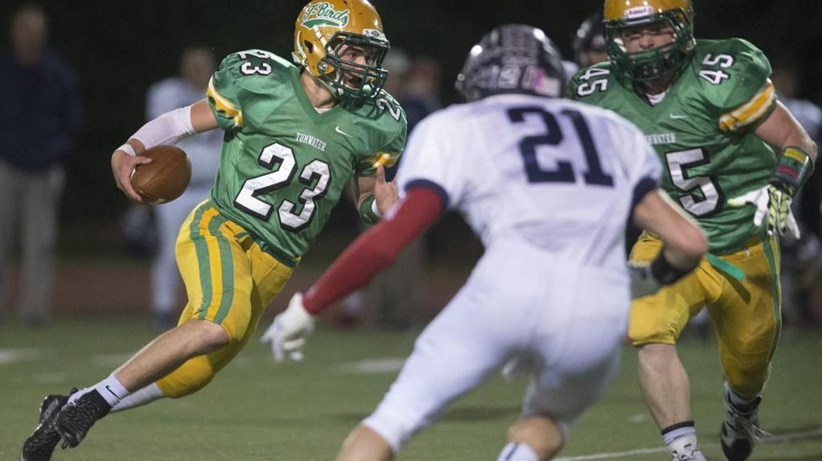 Tumwater running back Noah Andrews looks for a block from teammate Jarid Barrett against Black Hills defender Jordan March in October.