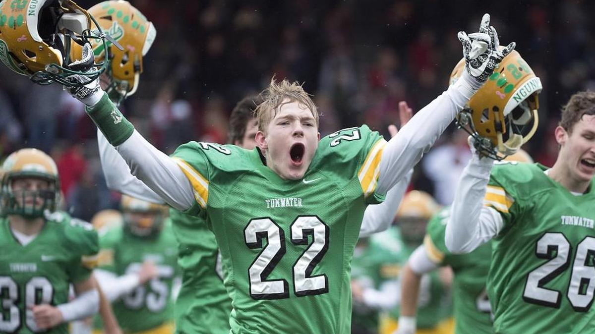 Tumwater seniors Jakob Holbrook (22) and Ethan Wilmovsky celebrate as time expires on the T-Birds' 10-6 state semifinal victory over Archbishop Murphy during Satuday's 2A state football semifinal at Sparks Stadium in Puyallup on Nov. 25, 2017.