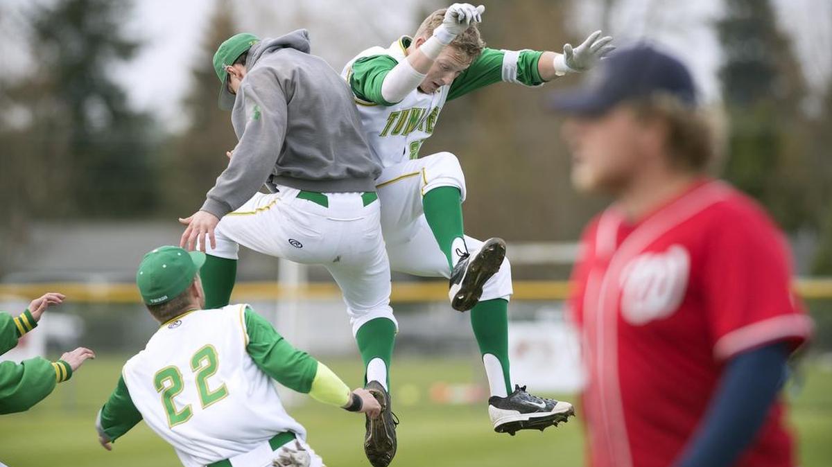 Tumwater’s Jacob Dardano (left) and Jackson Davis celebrate after Davis drove in the game-winning run in the bottom of the seventh inning against Black Hills on Wednesday.