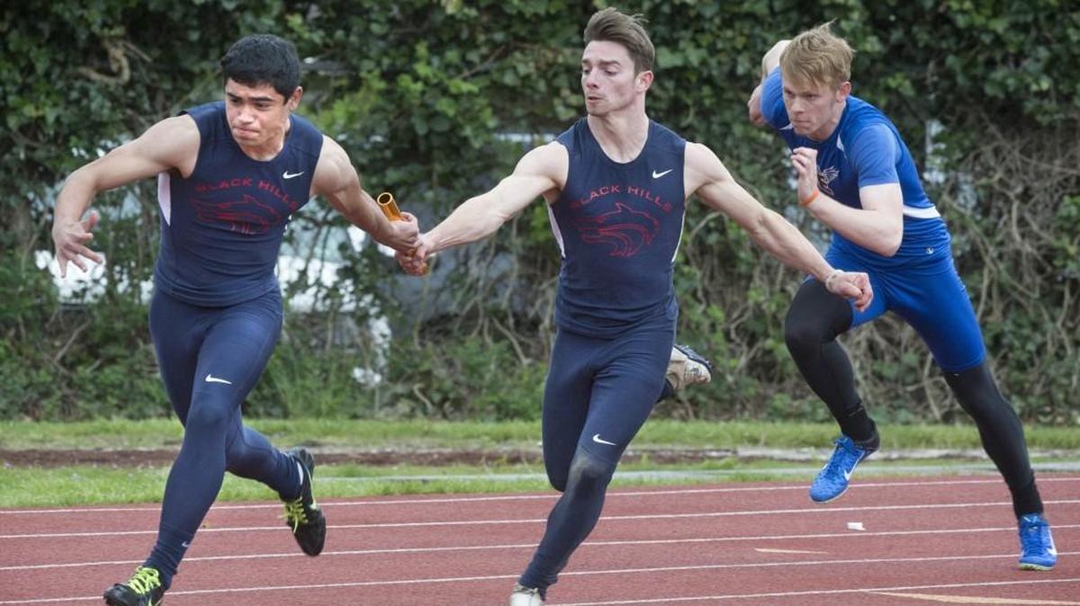 Black Hills' Christian Williams takes the baton from teammate Kyler Nygren on the opening pass of the boys 4x100-meter relay during the Chehalis Activators Classic track and field meet at W.F. West High School in Chehalis on Saturday, April 22, 2017.
