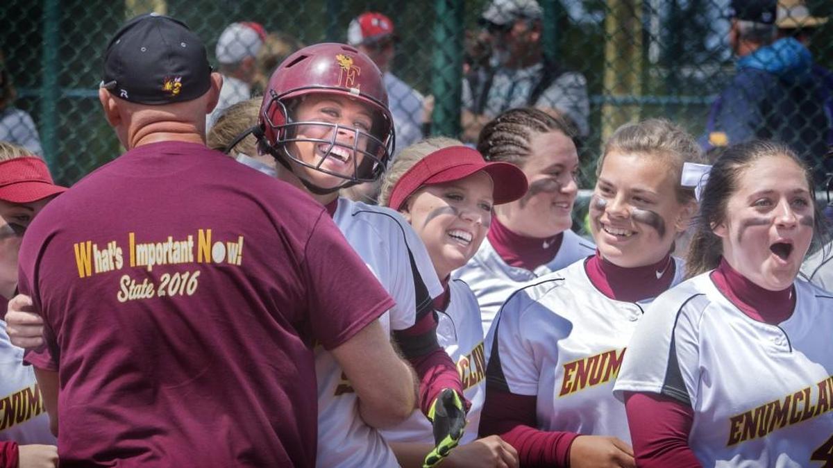 Enumclaw’s Quinn Breidenbach, with helmet, gets congratulated by coach Mike Eckhart at home plate, after hitting a walk-off home run in a 2-1 victory over West Seattle at Regional Athletic Complex in Lacey on Friday. Enumclaw advanced to the state semifinals with two victories on Friday.