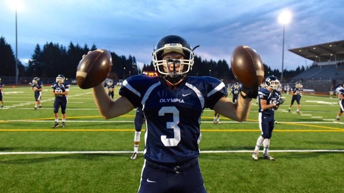 
Olympia senior quarterback Jack Bell warms up before Friday night's 4A Narrows League football game against Gig Harbor at Ingersoll Stadium in Olympia.
