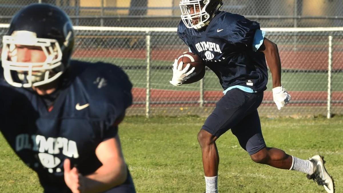 Senior Ibi Ceesay, shown returning a kickoff in a recent practice, is a triple-threat for Olympia. He is one of the area's leading receivers, plays safety and is a dangerous return man.