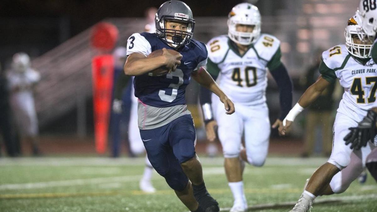 River Ridge running back Maleko Mina finds running room through the Clover Park defense during Thursday night's football game at South Sound Stadium in Lacey on Oct. 12, 2017.
