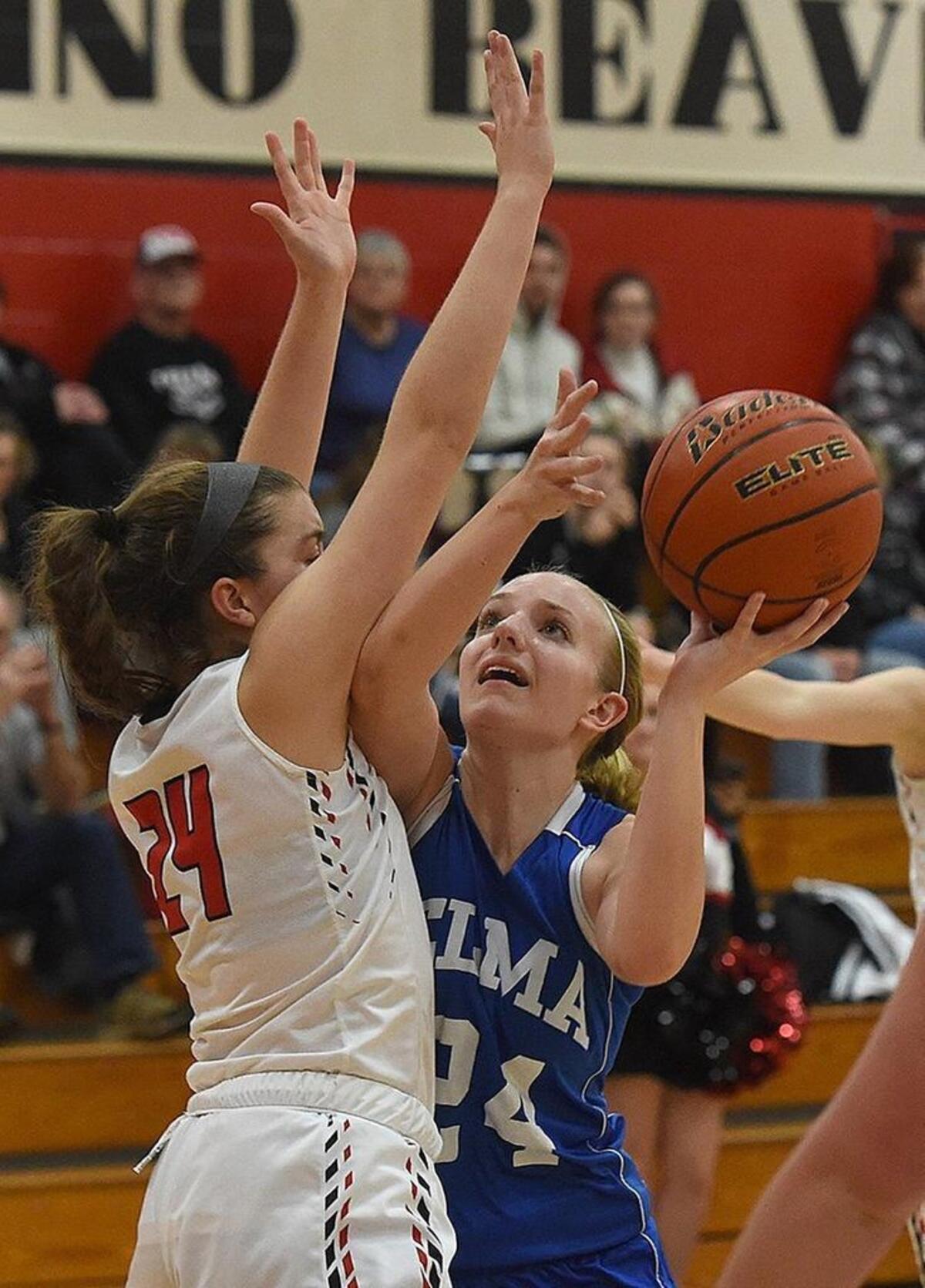 Elma’s Molly Johnston pivots to the basket against Tenino guard Kaylee Schow as the Eagles routed the Beavers on Thursday, Jan. 11, 2018 at Tenino High School.