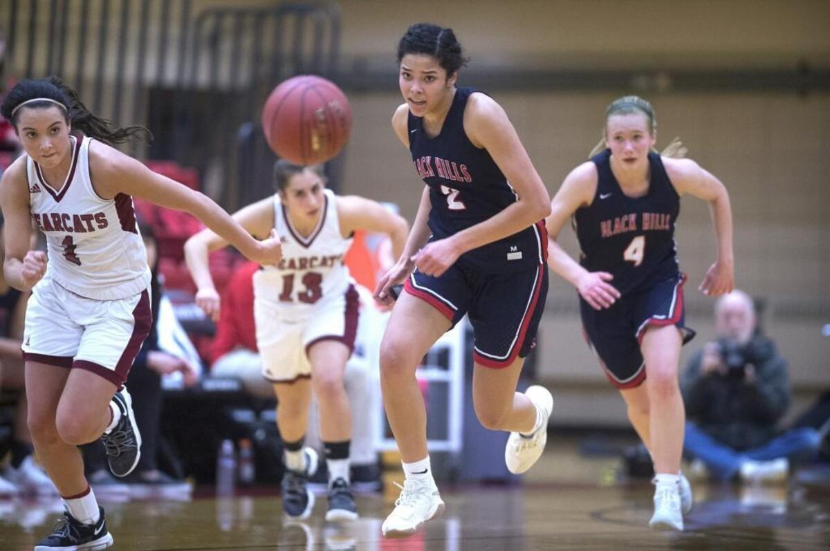 W.F. West’s Maggie Vadala (from left) and Kelly Robertson race for a loose ball against Black Hills’ Maisy Williams and Megan River during Friday night’s 2A Southwest District girls basketball championship game at Saint Martin’s University in Lacey on Friday, Feb. 16, 2018.