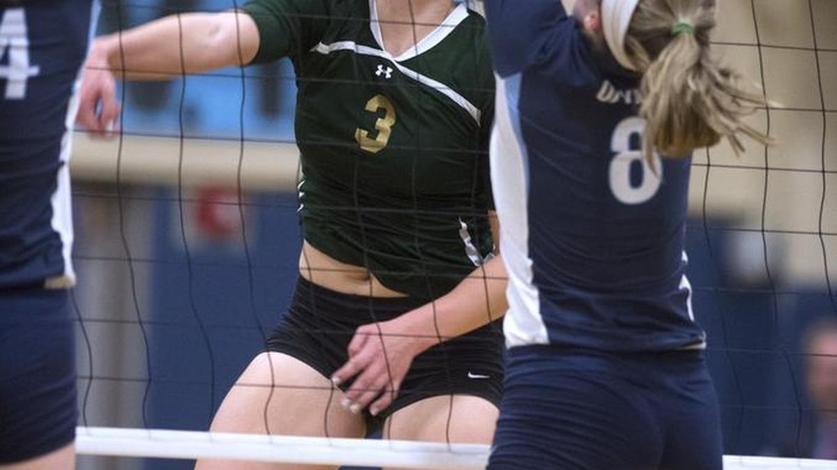 Timberline middle blocker Julianna Salanoa (3), firing a shot between a pair of Olympia defenders during an October match, was a first-team all-4A Narrows League selection this season.
