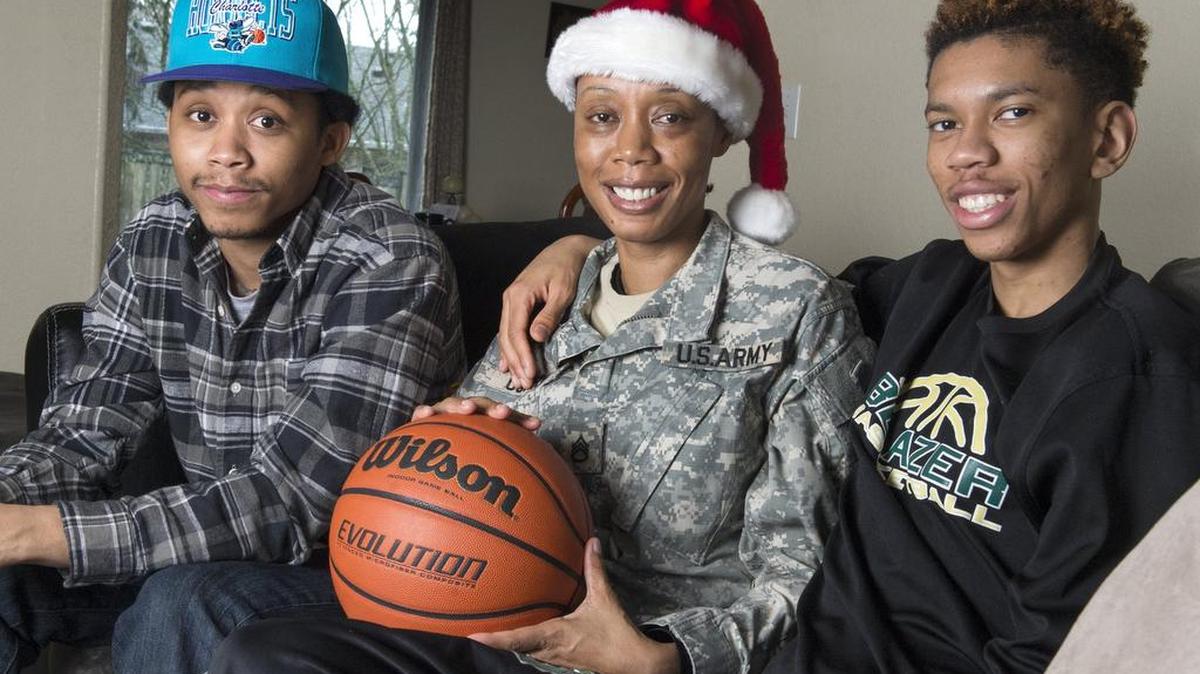 Austin Curry, right, and his brother Alex are happy to have their mom, Aretha, home for Christmas this year. She has served Army deployments to Iraq and Afghanistan. .