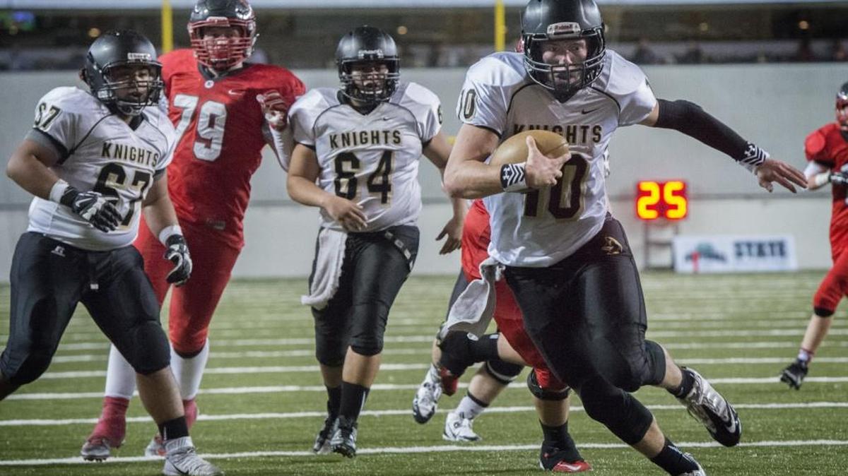 Royal quarterback Kaden Jenks looks for a clear path into the end zone to score a touchdown in the WIAA 1A state championship game at the Tacoma Dome.