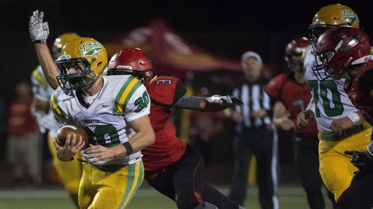 Tumwater's Dylan Paine rushes but is stopped by TJ Page (3) in the fourth quarter. Steilacoom played Tumwater in a football game at Steilacoom high school in Tacoma, Wash., on Thursday, Sept. 28, 2017.
