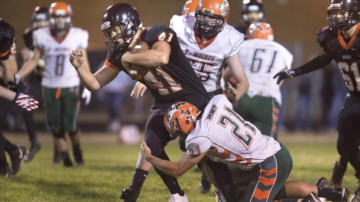Rainier senior running back Ian Russell carries the ball during a football game against Morton-White Pass at Rainier High School on Sept. 21, 2017.