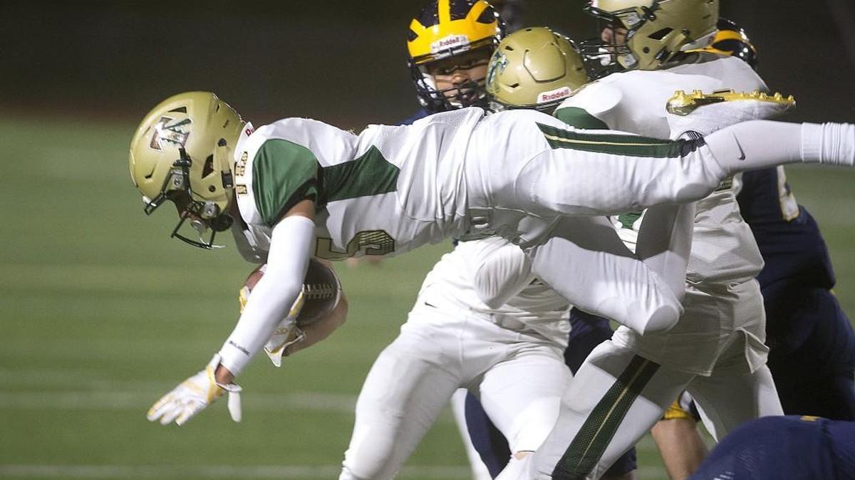 Timberline kick returner Colton Steepy goes airborne on a kickoff return against Bellevue during Saturday night's 3A state football quarterfinal game at Bellevue High School on Nov. 18, 2017.