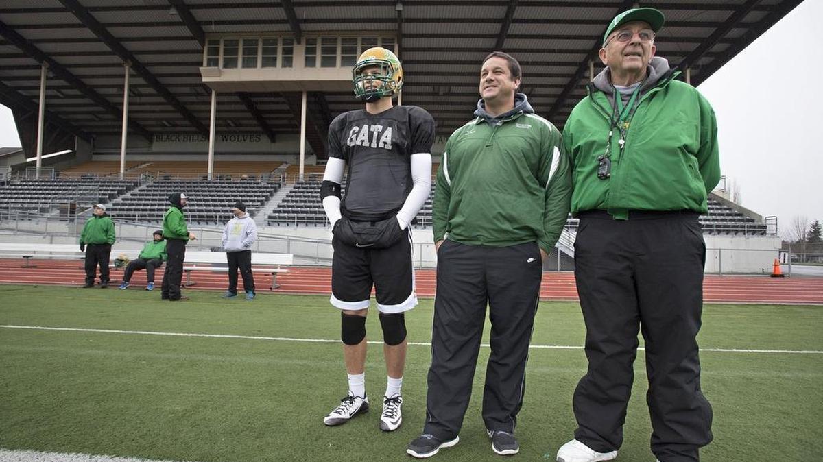 Tumwater junior Cade Otton, from left, watches his team practice this week along with his father, defensive line coach Tim Otton, and his grandfather, head coach Sid Otton.