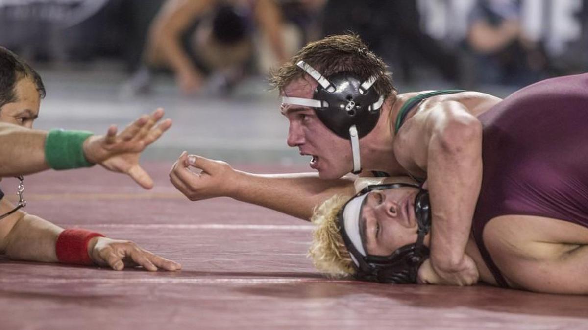 Cy Hicks of Tumwater wins his 285-pound match against top-ranked Jonathan Cuevas of Toppenish. “He’s really good. He’s one of the best,” Hicks said.
