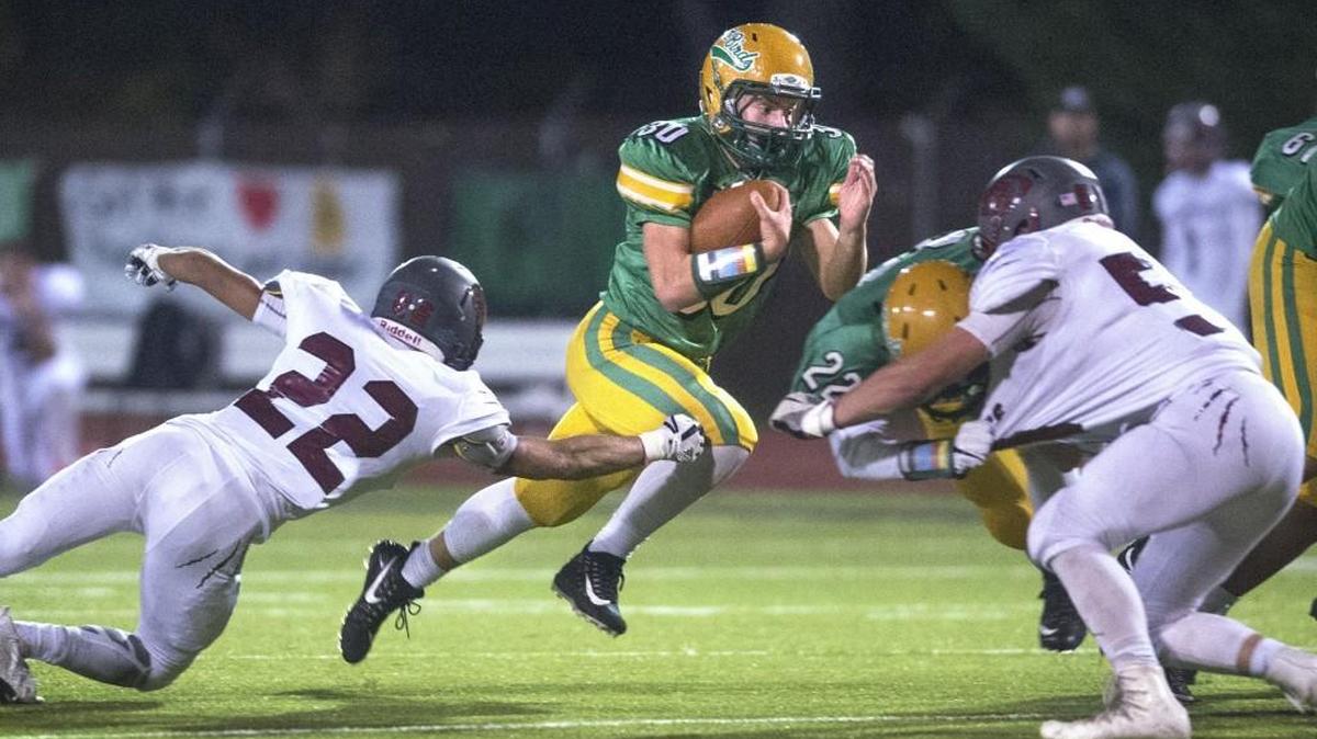 Tumwater running back Dylan Paine cuts between WF West defenders Jett Bowers (22) and Camden Bull during Friday night’s football game at Tumwater District Stadium on Oct. 27, 2017.