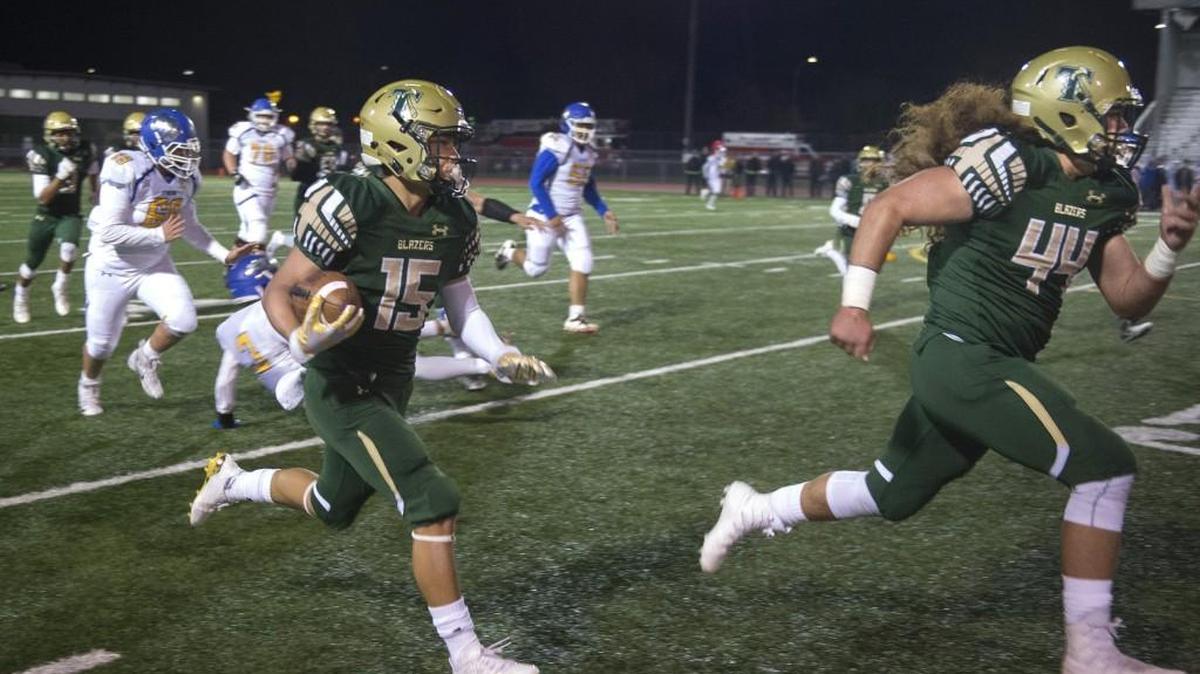 TImberline cornerback Colton Steepy follows teammate Mason Simeta after intercepting a Stadium pass - his second interception of the first quarter - during Friday night's playoff football game against Stadium at South Sound Stadium in Lacey on Nov. 3, 2017. The interception was nullified by a roughing the passer penalty by Timberline.