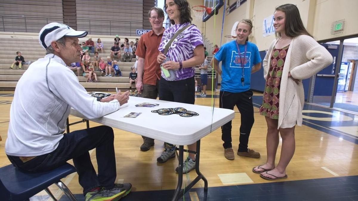 Olympic distance runner, author, inspirational speaker and trainer Jeff Galloway talks with North Thurston High cross country coach Heidi Perry and runners Sophia Risvold (right) and Mirin Morris-Ward before his presentation at Olympia High School on Friday. Second from left is Perry’s boyfriend, John Pearch.