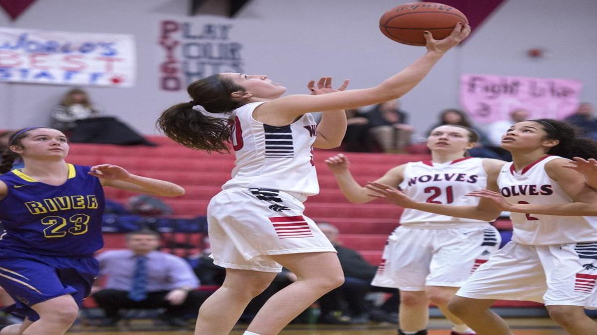 Black Hills sophomore guard Lindsey Nurmi drives the baseline for a reverse layup in front of Columbia River defender Anna Klundt and teammates Sammi Payne (21) and Maisy Williams on Tuesday.
